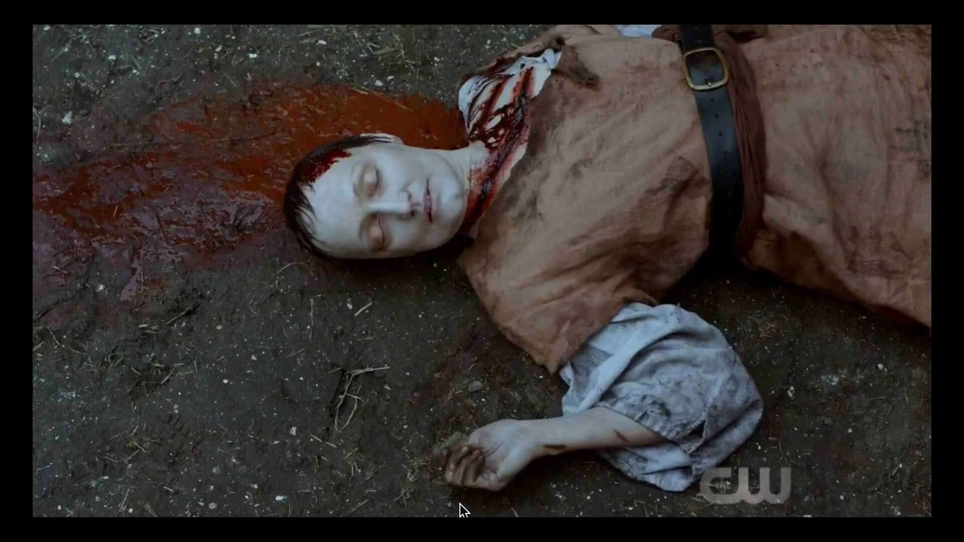 Still from The Outpost. Julie-Anne lies dead, brutally slashed in medieval/fantasy attire.
